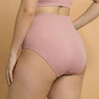 Person wearing pink high-waisted bikini bottoms on a beige background