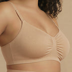 Beige bra worn by a person on a beige background